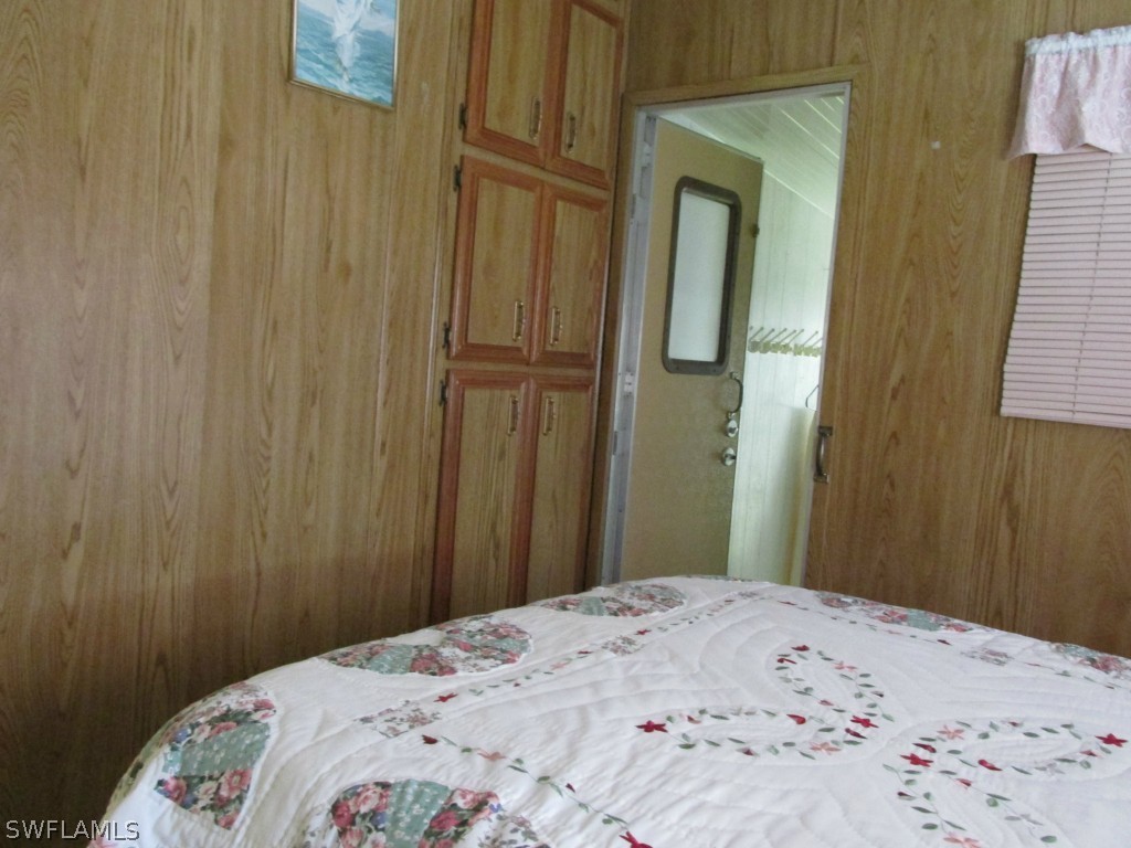 19681 Summerlin Road, Unit 208 Fort Myers, FL 33908 - Photo 3 of 3 a bedroom with a bed and wooden floor