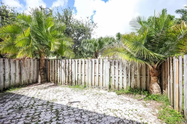 a backyard of a house with lawn chairs