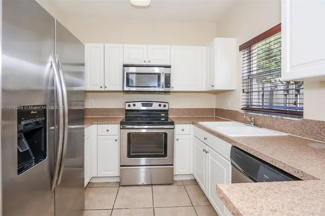 a kitchen with a stove microwave and refrigerator