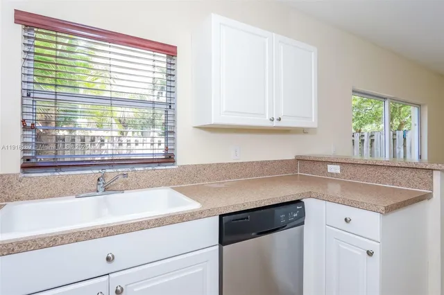 a kitchen with granite countertop a sink and a window