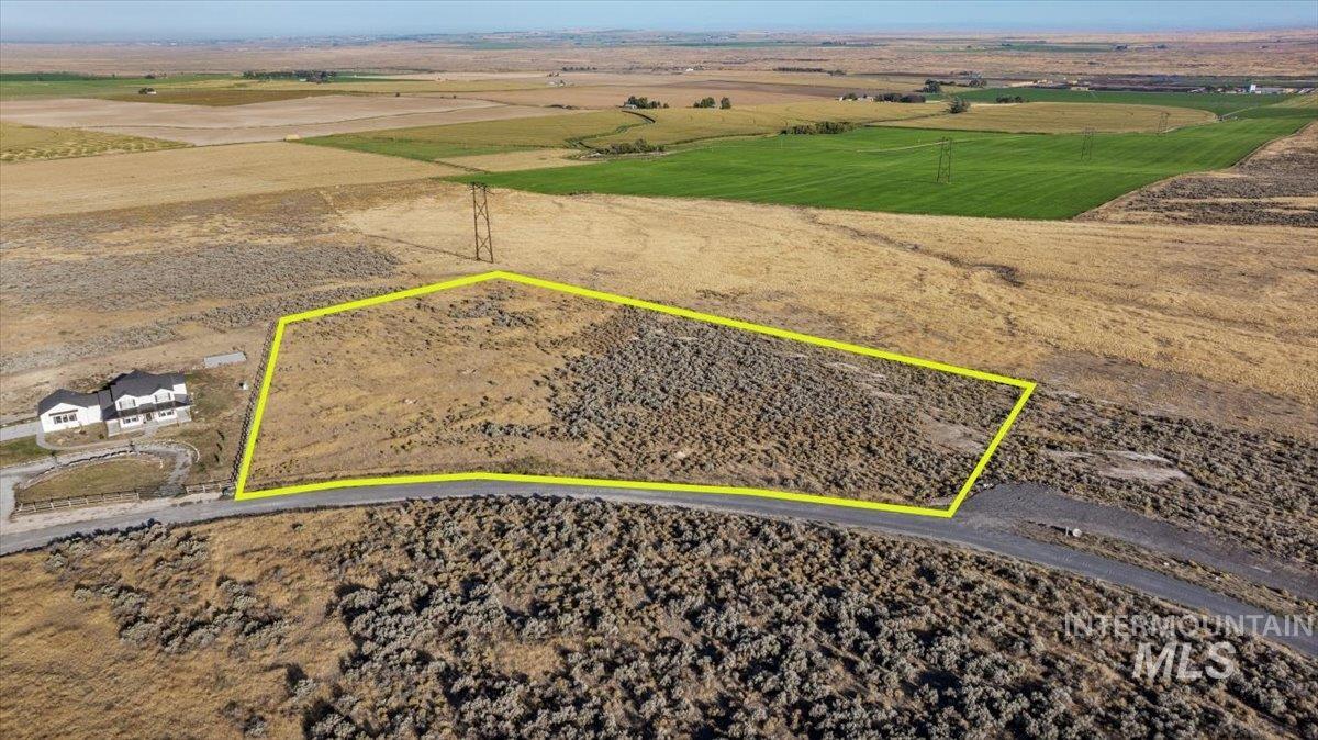 Aerial view of sparsely populated area featuring property boundaries highlighted