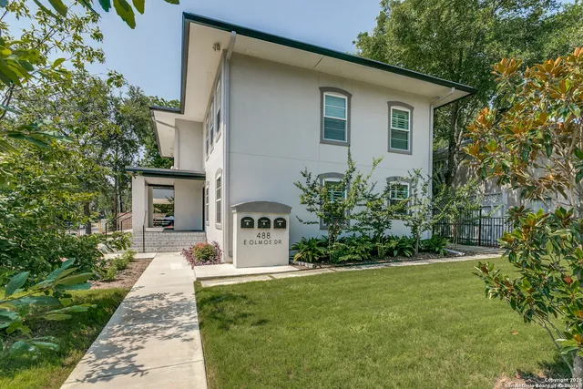 a front view of a house with garden