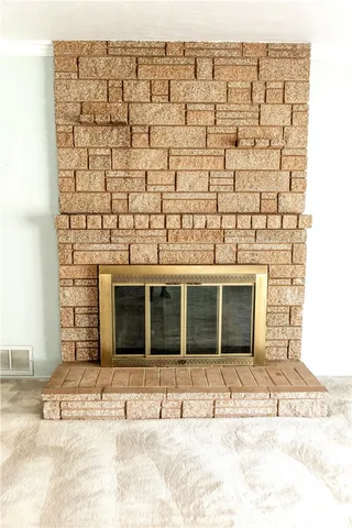 a view of a brick house with large windows