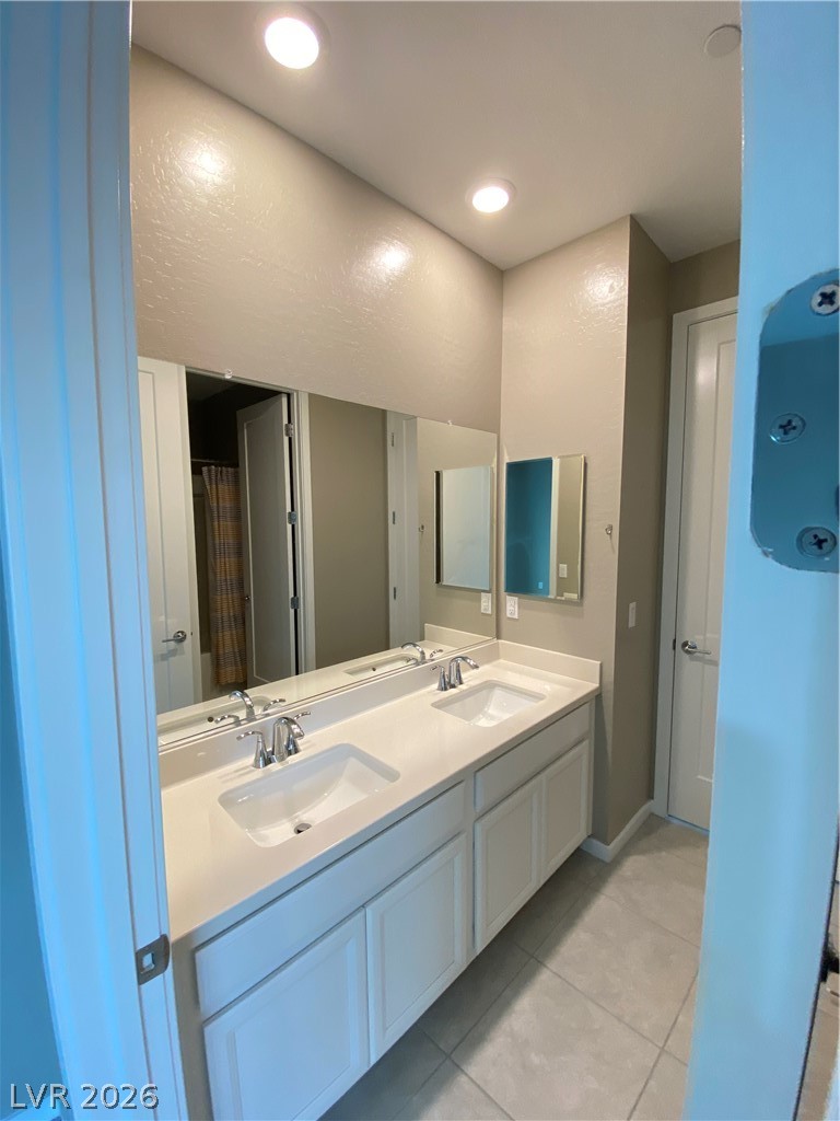 695 Daylight Ridge Court Henderson, NV 89052 - Photo 23 of 27 Bathroom featuring curtained shower, double vanity, light tile patterned floors, and recessed lighting