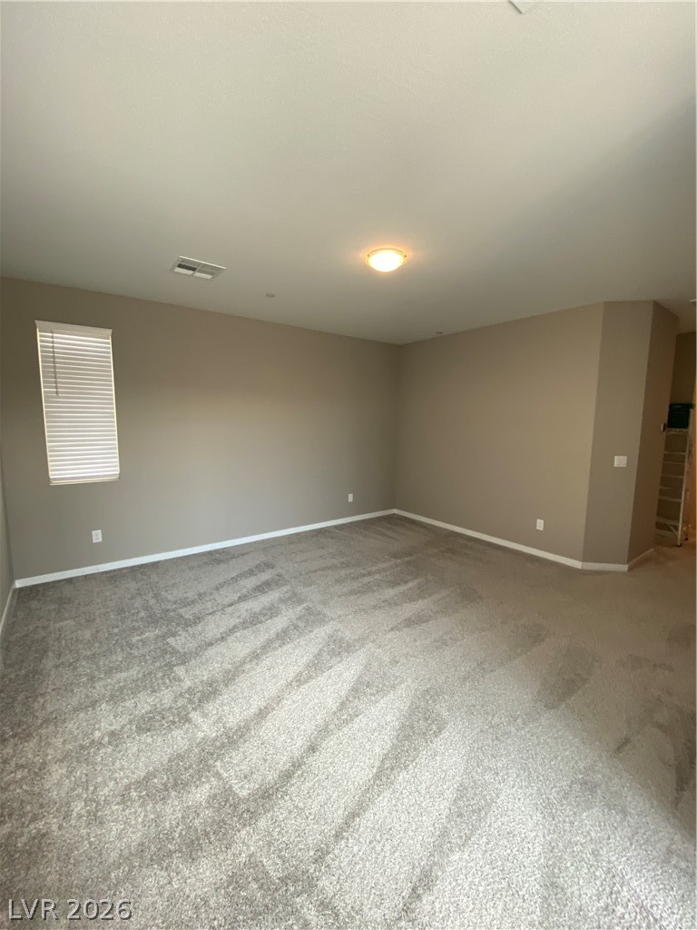 695 Daylight Ridge Court Henderson, NV 89052 - Photo 26 of 27 Spare room featuring light colored carpet and baseboards