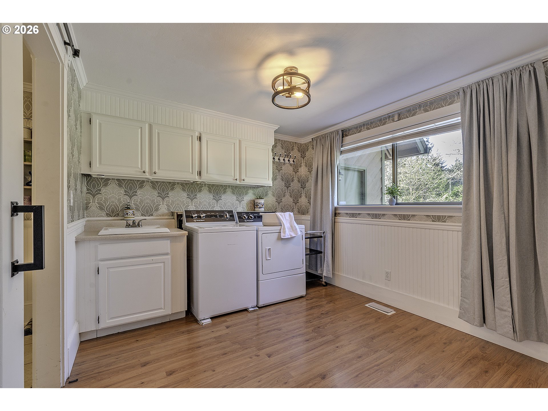 34049 West Campbell Loop Seaside, OR 97138 - Photo 21 of 48 a kitchen with kitchen island white cabinets and white appliances