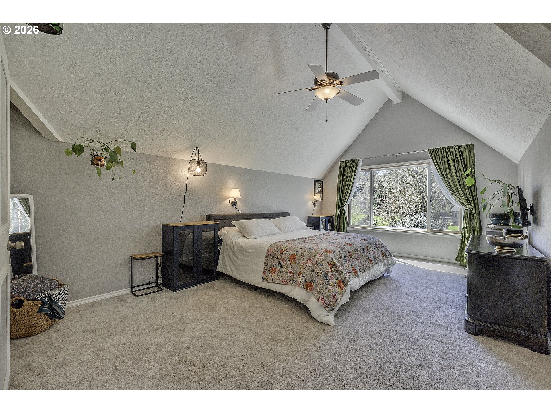 34049 West Campbell Loop Seaside, OR 97138 - Photo 27 of 48 a bedroom with a large bed and a chandelier