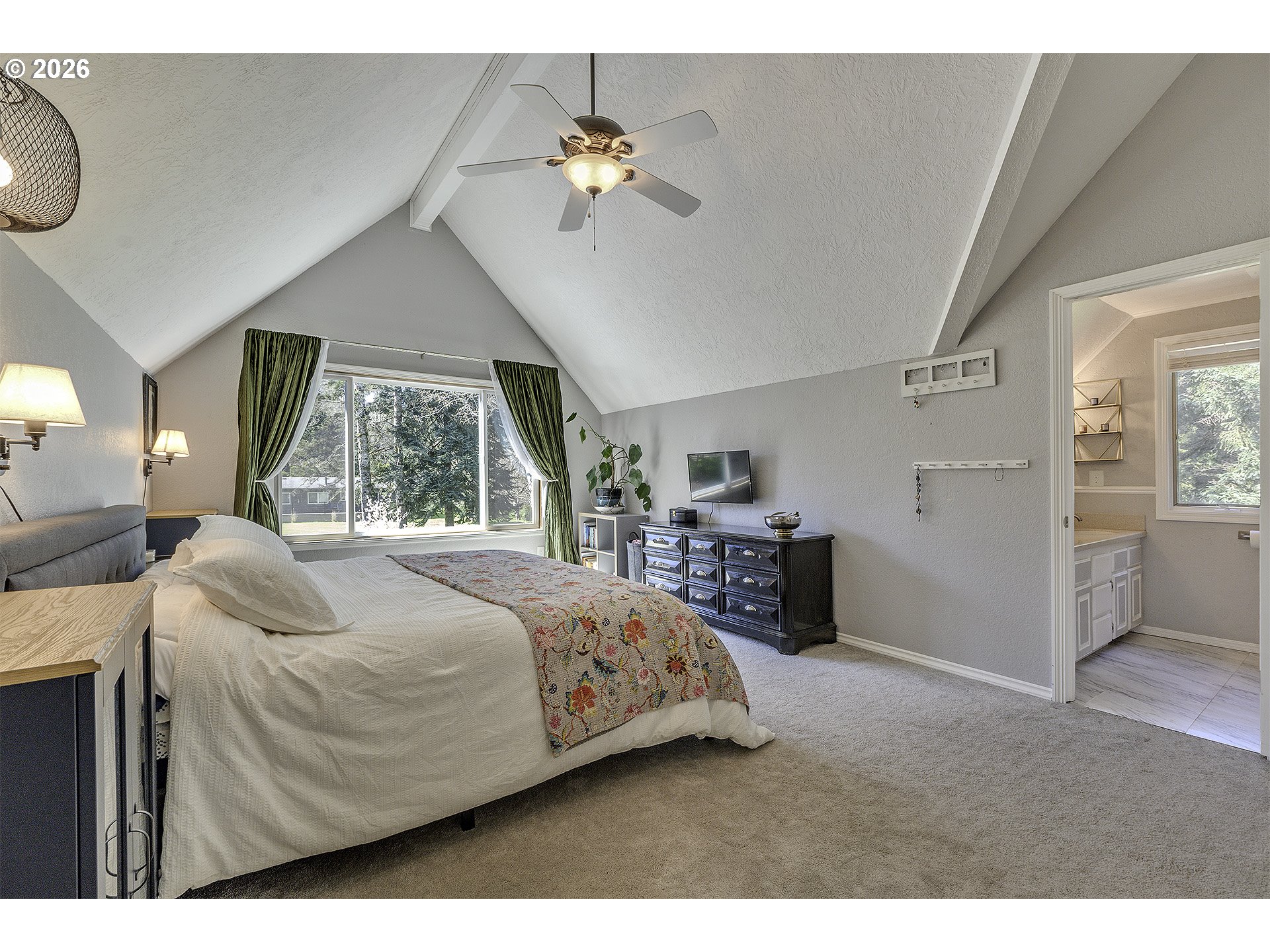 34049 West Campbell Loop Seaside, OR 97138 - Photo 28 of 48 a bedroom with a large bed and a chandelier
