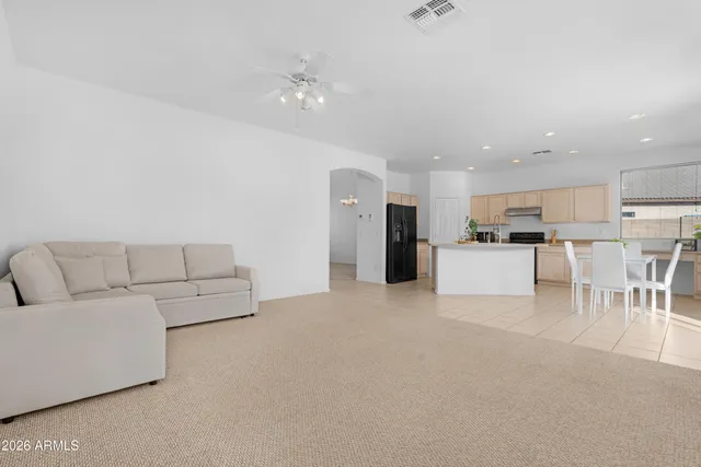 a living room with furniture and a ceiling fan
