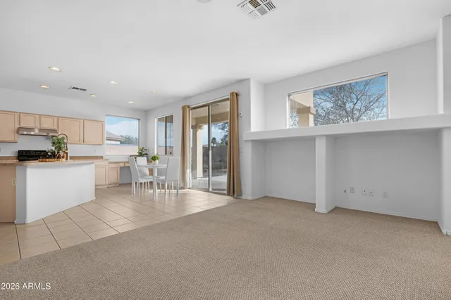 a living room with furniture and kitchen view