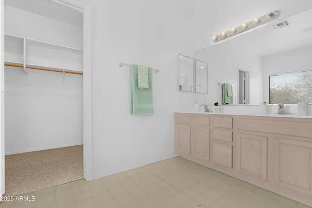 a bathroom with a sink vanity and mirror