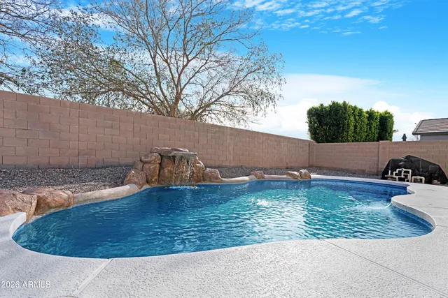 a view of a swimming pool with a yard