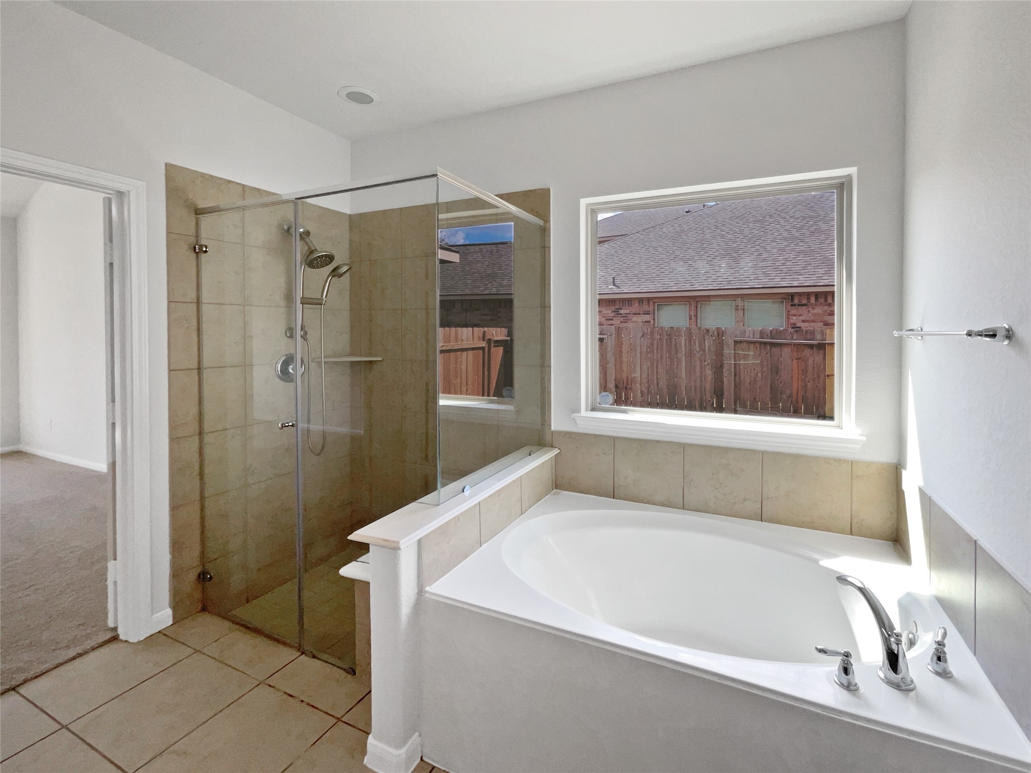 7323 Collins Manor Drive Spring, TX 77389 - Photo 15 of 22 a bathroom with a tub a sink and a window