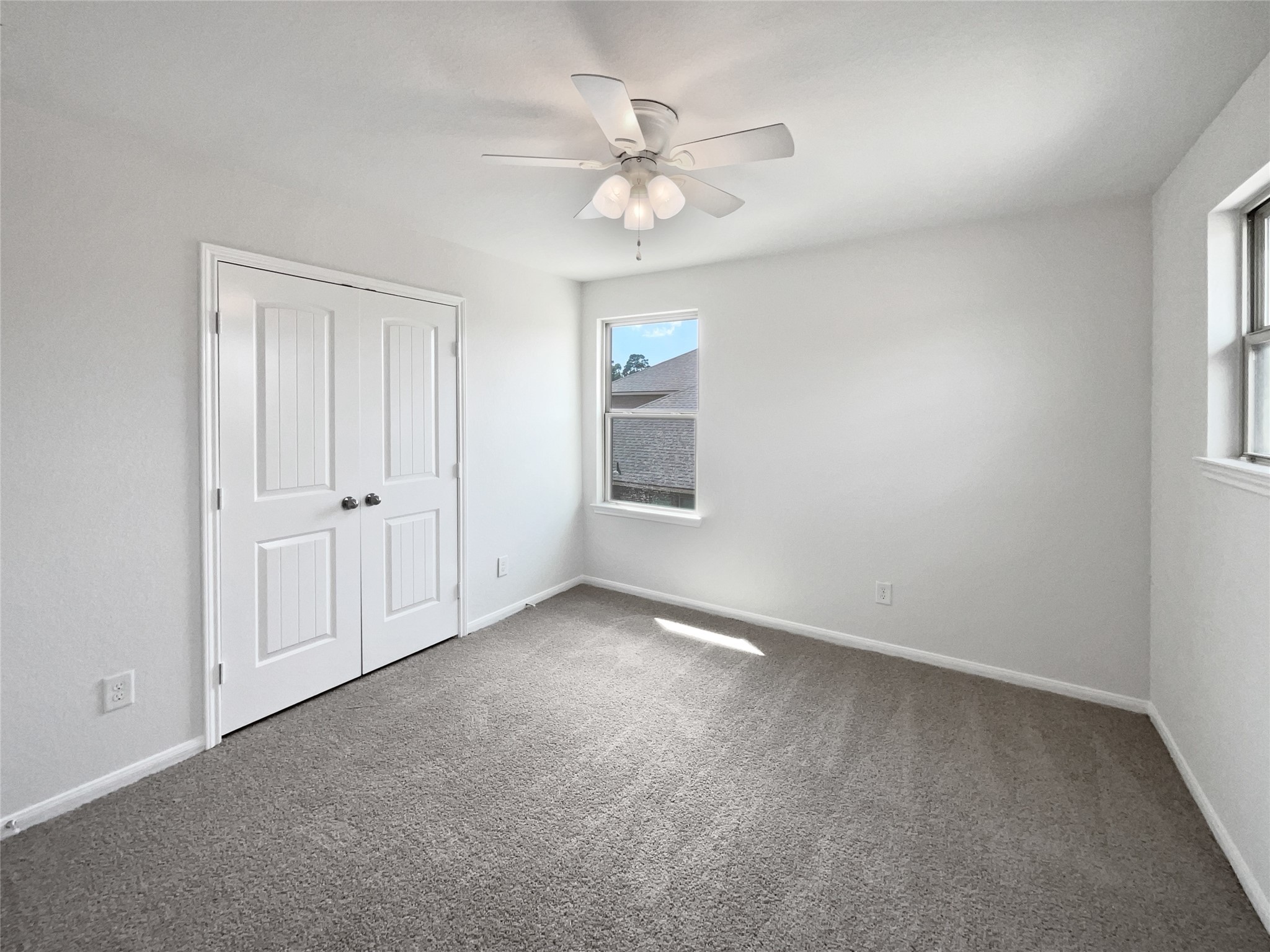 7323 Collins Manor Drive Spring, TX 77389 - Photo 17 of 22 an empty room with fan and windows