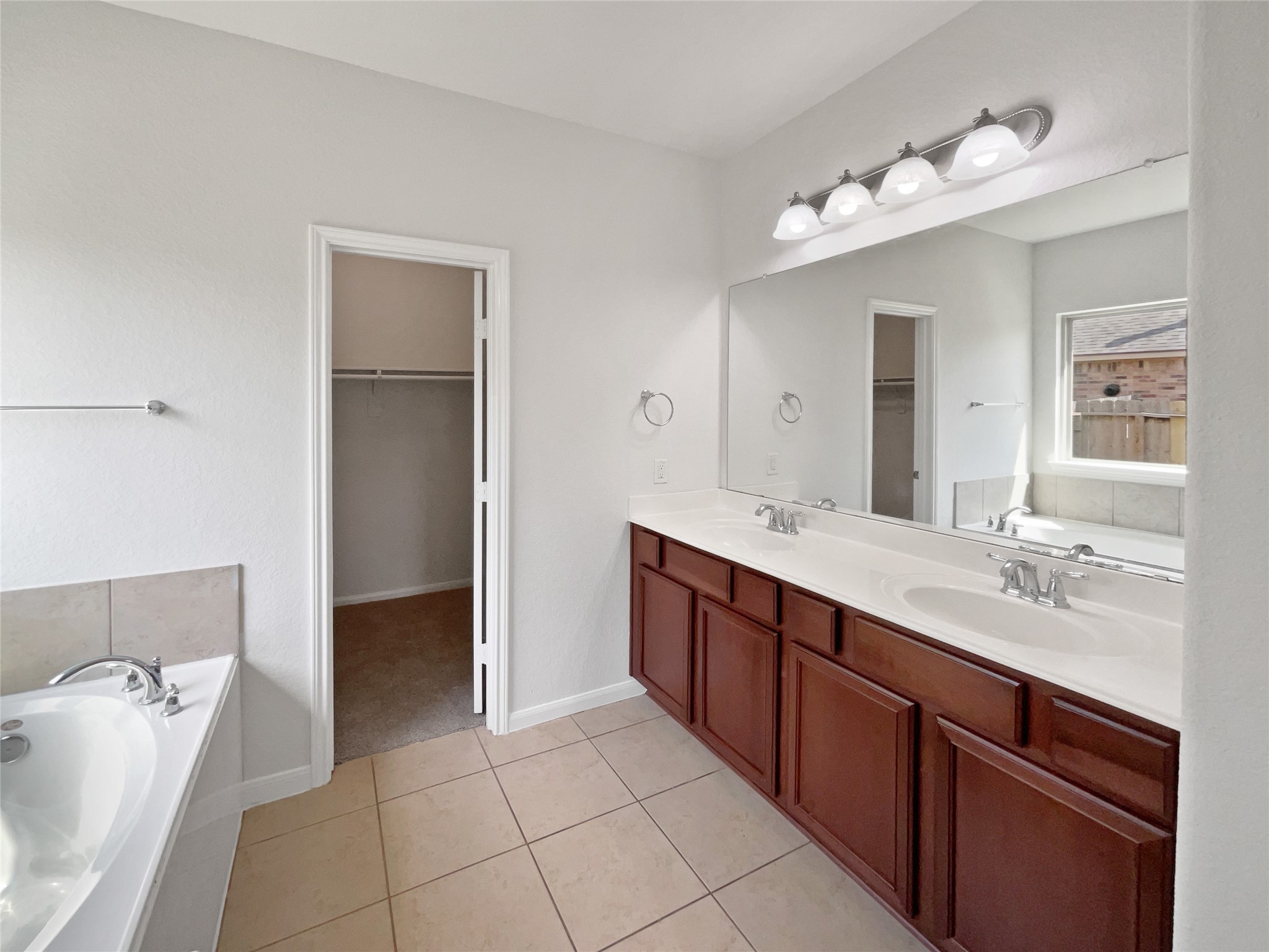 7323 Collins Manor Drive Spring, TX 77389 - Photo 7 of 22 a spacious bathroom with a granite countertop sink a mirror and a bathtub