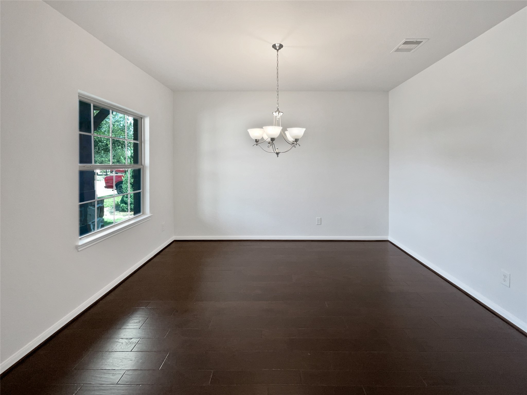 7323 Collins Manor Drive Spring, TX 77389 - Photo 9 of 22 an empty room with wooden floor and windows