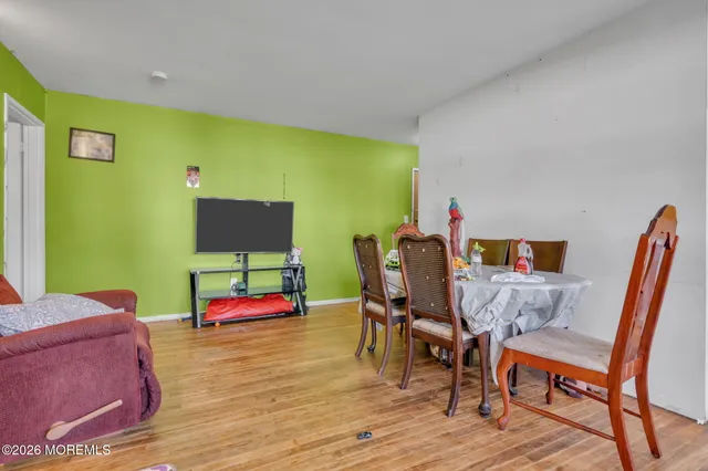 a bedroom with furniture and a wooden floor