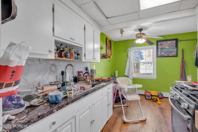 a room with furniture a rug toys and a window