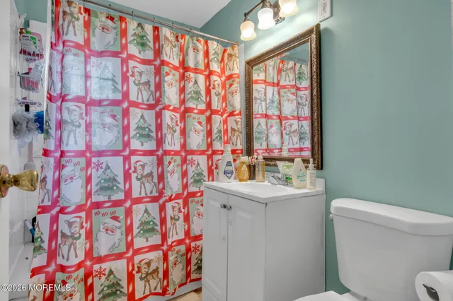 a bathroom with a sink and mirror with toilet