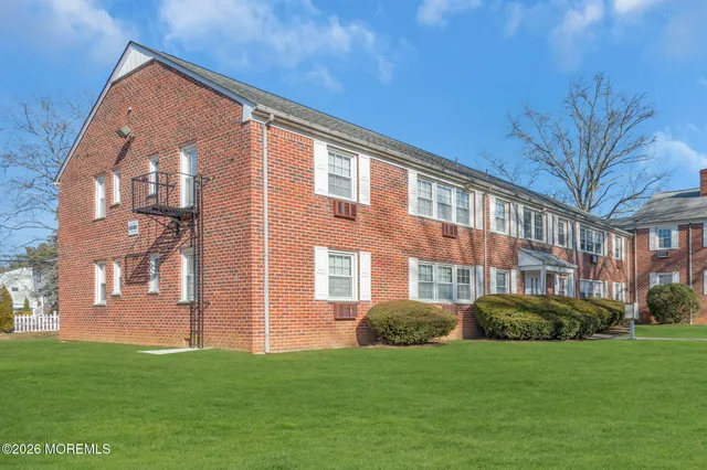 a front view of building with yard