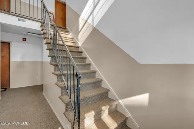 a view of entryway and gallery with wooden floor