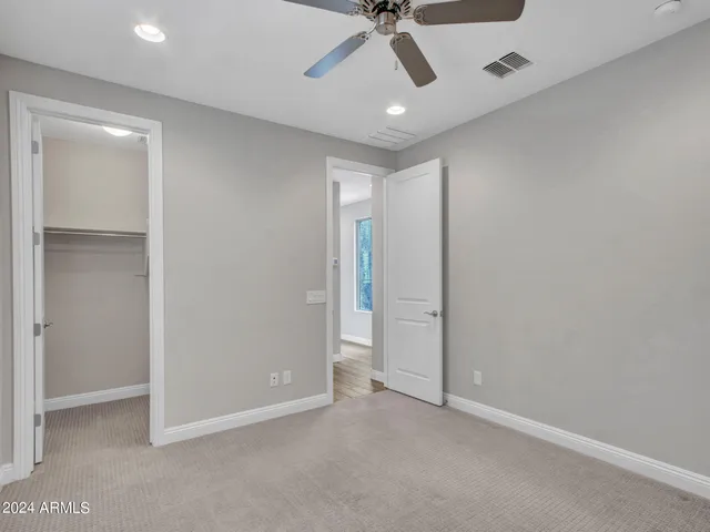 a bathroom with a sink a toilet and a large mirror