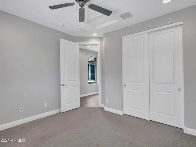 a view of an empty room and a ceiling fan