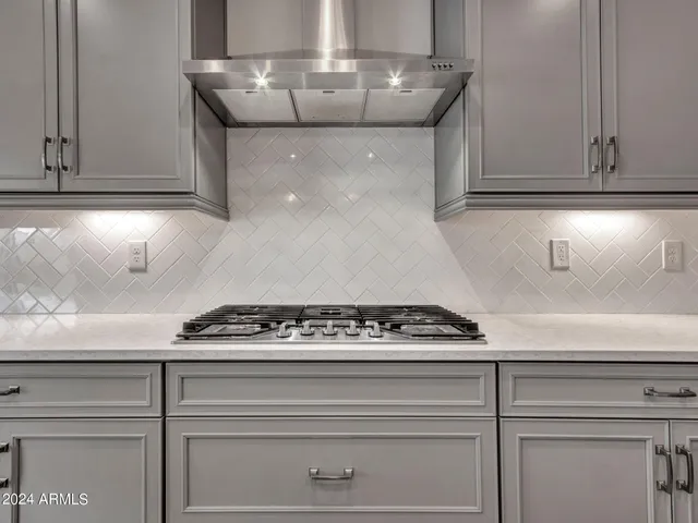 a kitchen with a refrigerator a sink and cabinets