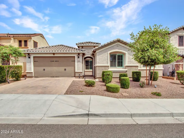 a front view of a house with a yard and garage