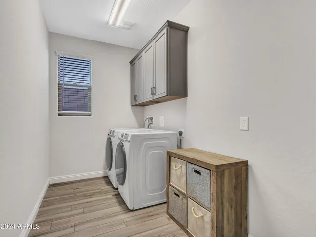 a view of a patio with table and chairs with wooden floor and fence