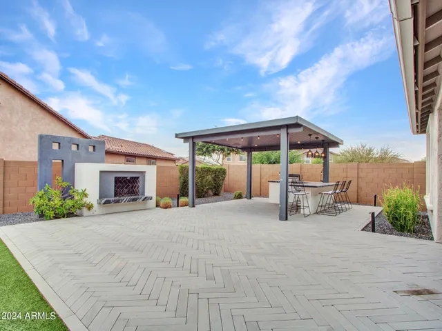 a front view of a house with a garden and yard