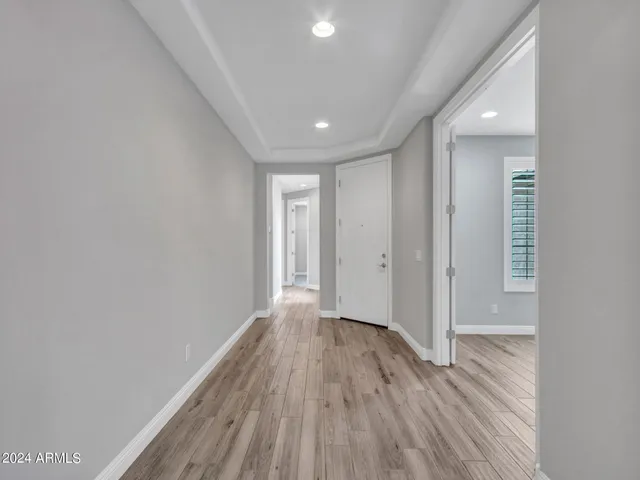 a view of a hallway with wooden floor