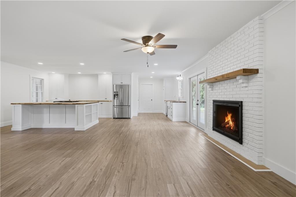 125 Childers Road Canton, GA 30115 - Photo 13 of 48 a view of an empty room with wooden floor a fireplace and a window
