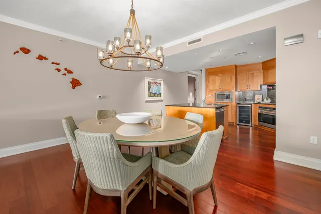 a view of a dining room with furniture wooden floor and chandelier