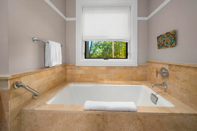 a bath tub sitting in a bathroom next to a window