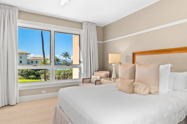 a bedroom with a large bed and a large window