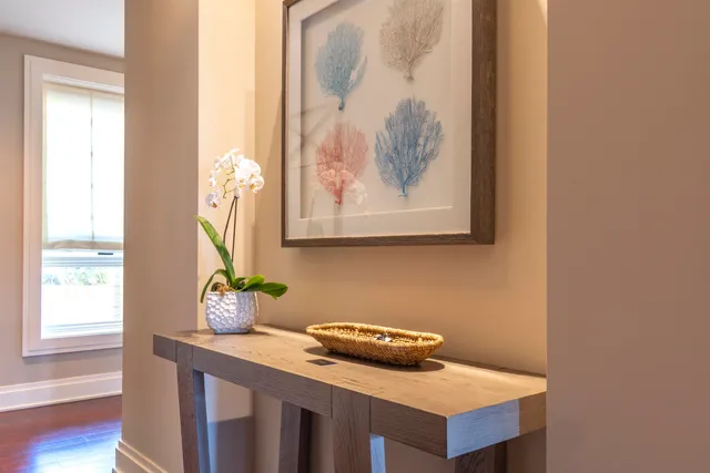 a room with a table chairs and a window