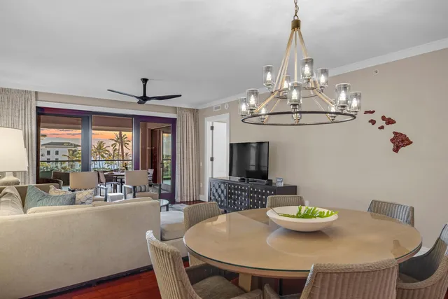 a view of a dining room with furniture a chandelier and wooden floor
