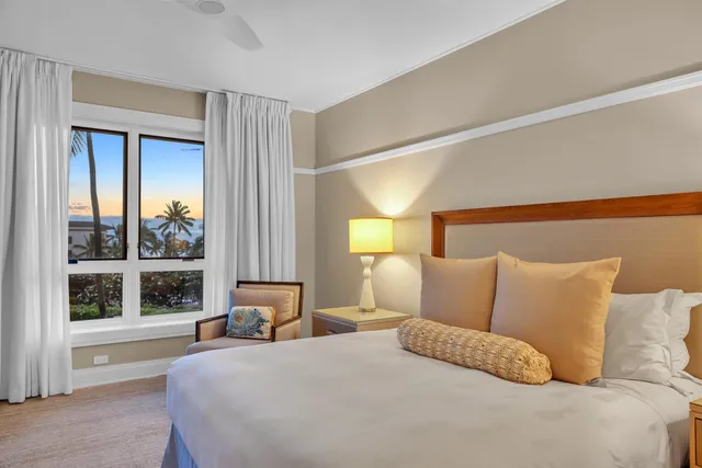 a bedroom with a large bed and a large window