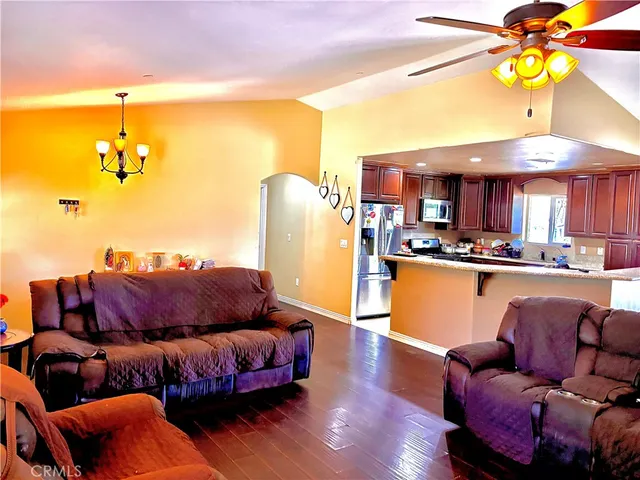 a living room with furniture and a kitchen