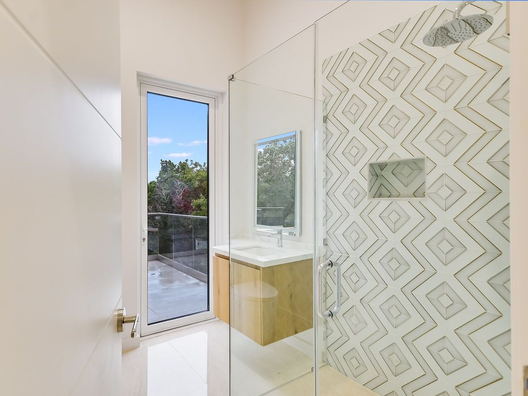 2476 Waymaker Way Austin, TX 78746 - Photo 19 of 31 A sleek, contemporary bathroom with a custom tiled shower and a private balcony access.