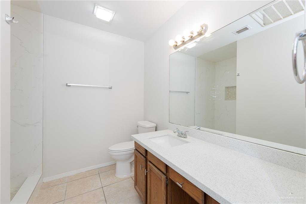 500 East El Rancho Avenue, Unit 26 McAllen, TX 78503 - Photo 13 of 27 a bathroom with a sink a toilet and a mirror