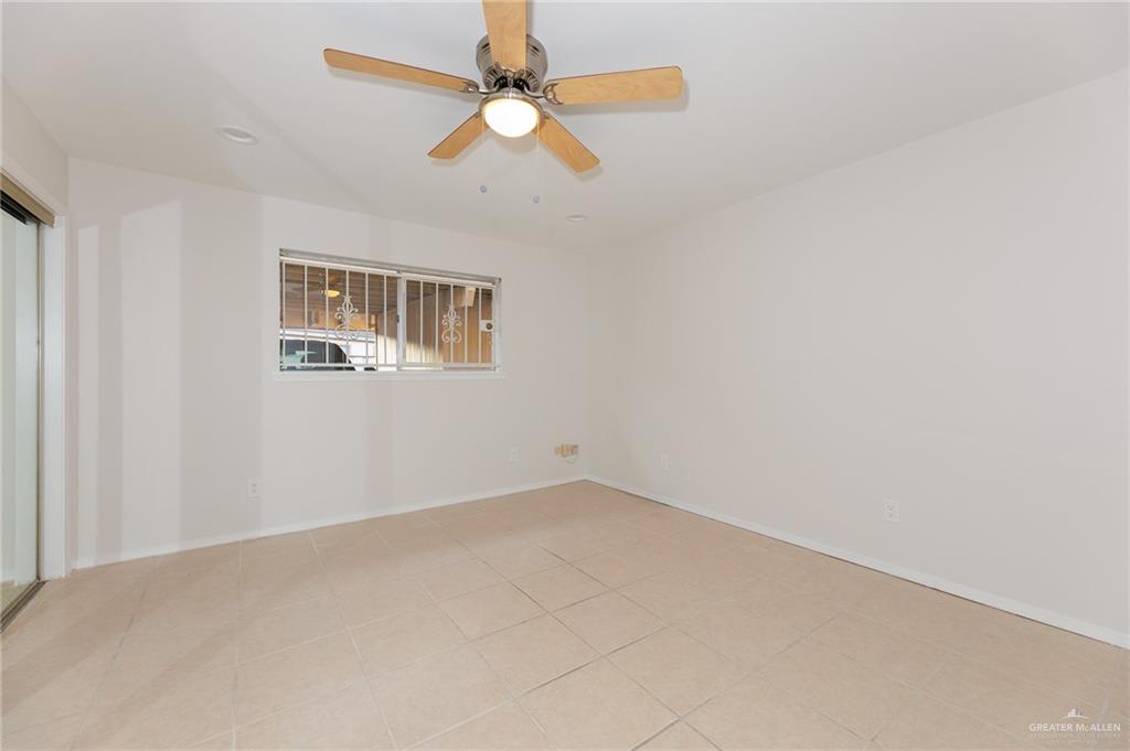 500 East El Rancho Avenue, Unit 26 McAllen, TX 78503 - Photo 15 of 27 an empty room with a chandelier fan and windows