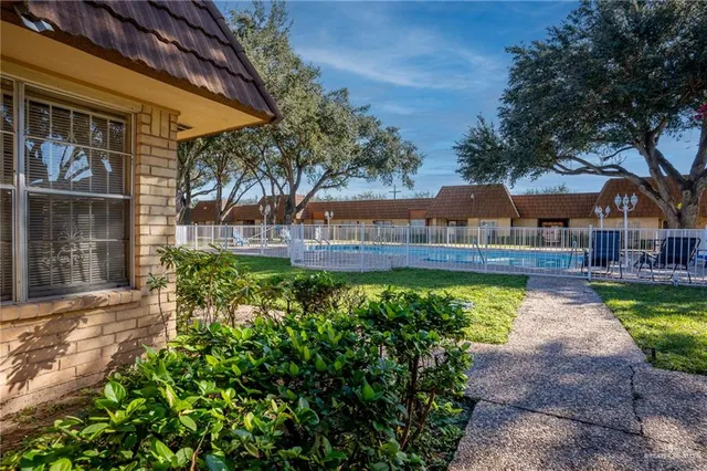 a view of a house with a yard and sitting area