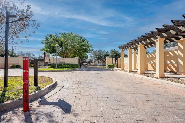 a view of swimming pool with lawn chairs and plants
