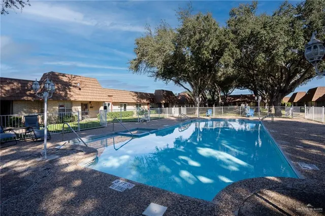 a view of a swimming pool with lounge chairs