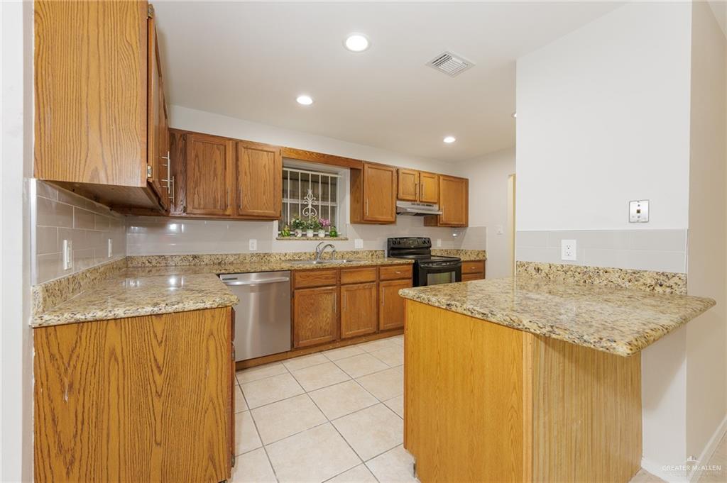 500 East El Rancho Avenue, Unit 26 McAllen, TX 78503 - Photo 8 of 27 a kitchen with a sink a stove top oven and cabinetry