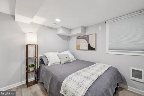 a bedroom with a bed and a painting on the wall