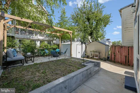 a view of a house with a yard and sitting area