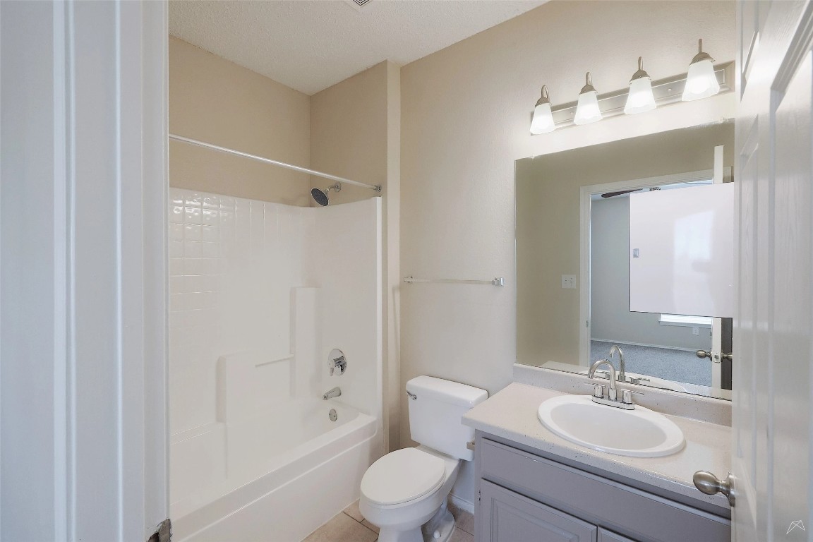11908 Anderson Mill Road, Unit 1121 Austin, TX 78726 - Photo 17 of 24 Bathroom featuring bathing tub / shower combination, vanity, and light tile patterned flooring